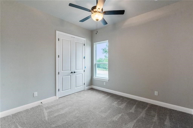 unfurnished bedroom with carpet floors, a closet, and ceiling fan