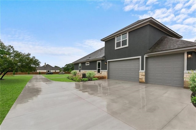 view of front facade with a garage and a front lawn