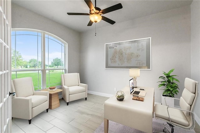 sitting room featuring ceiling fan