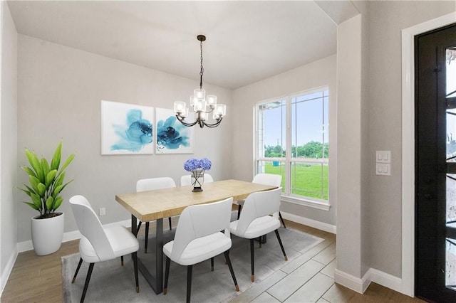 dining room with a chandelier and light wood-type flooring