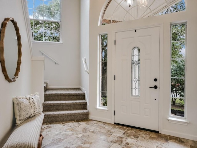 foyer entrance with a healthy amount of sunlight and vaulted ceiling