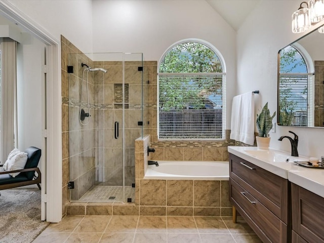 bathroom featuring tile patterned flooring, vanity, lofted ceiling, and shower with separate bathtub