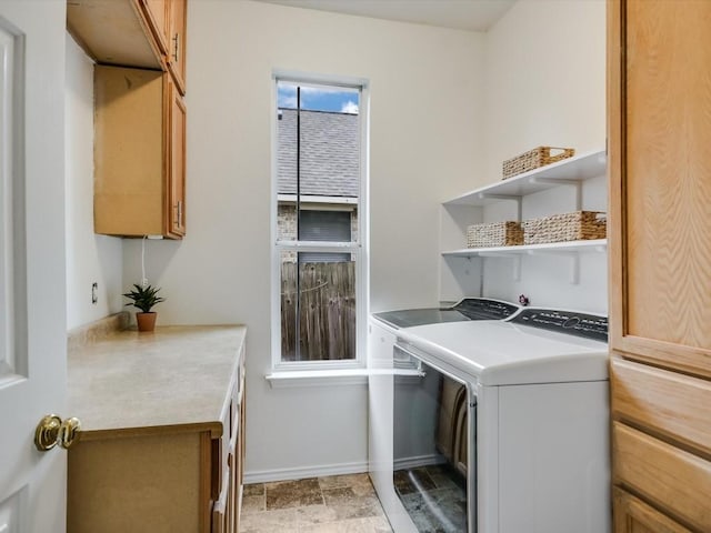 laundry room featuring cabinets and washer and clothes dryer