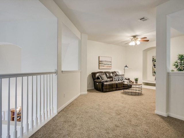 carpeted living room with ceiling fan