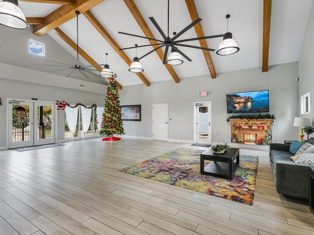 living room featuring french doors, light wood-type flooring, high vaulted ceiling, and ceiling fan