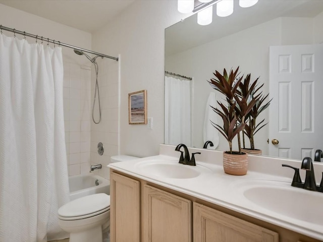 full bathroom featuring vanity, shower / bath combination with curtain, and toilet