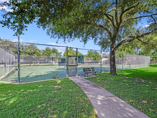 view of sport court with a lawn