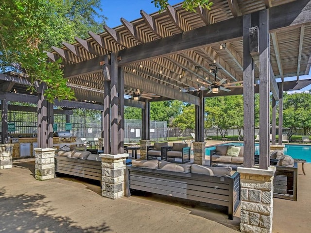 view of property's community with a pergola, an outdoor living space, exterior kitchen, a pool, and a patio