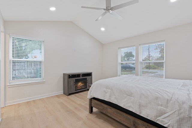 bedroom featuring light wood-type flooring, ceiling fan, and lofted ceiling