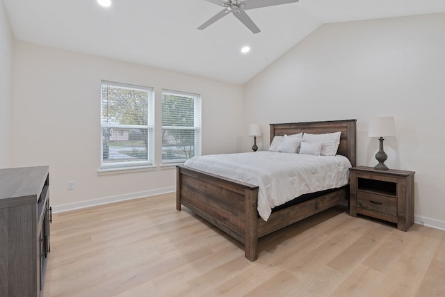 bedroom with ceiling fan, light hardwood / wood-style floors, and lofted ceiling