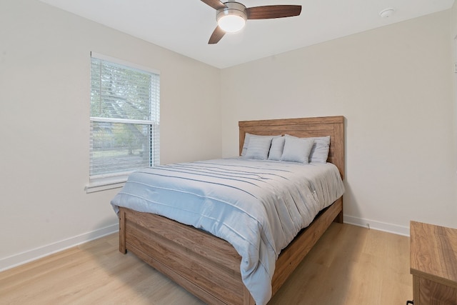 bedroom with ceiling fan and light hardwood / wood-style floors