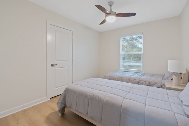 bedroom with ceiling fan and light wood-type flooring