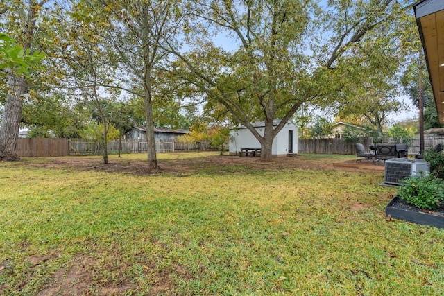 view of yard with cooling unit and a storage shed