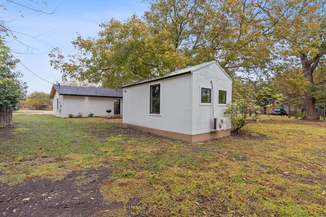 view of property exterior featuring a lawn and ac unit