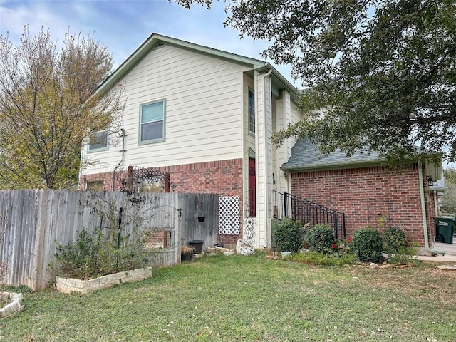 rear view of house featuring a yard