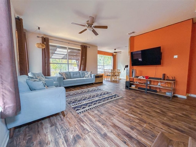 living room featuring hardwood / wood-style floors and ceiling fan