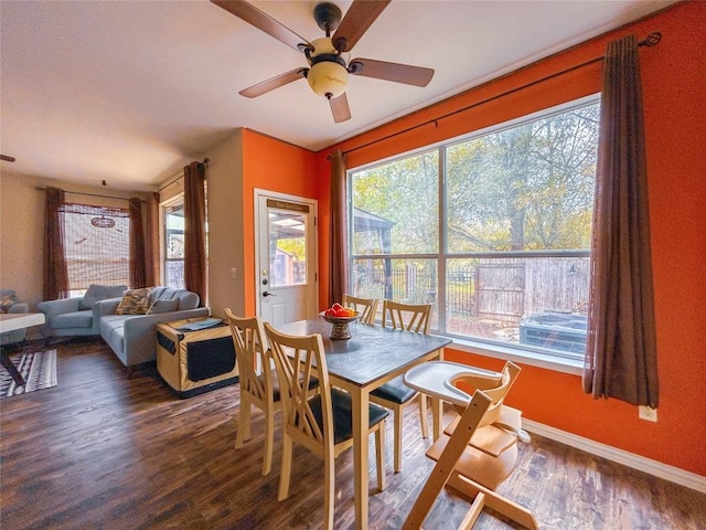 dining area with ceiling fan and dark hardwood / wood-style floors