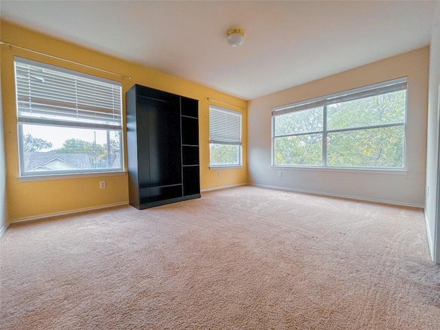 unfurnished bedroom featuring light carpet