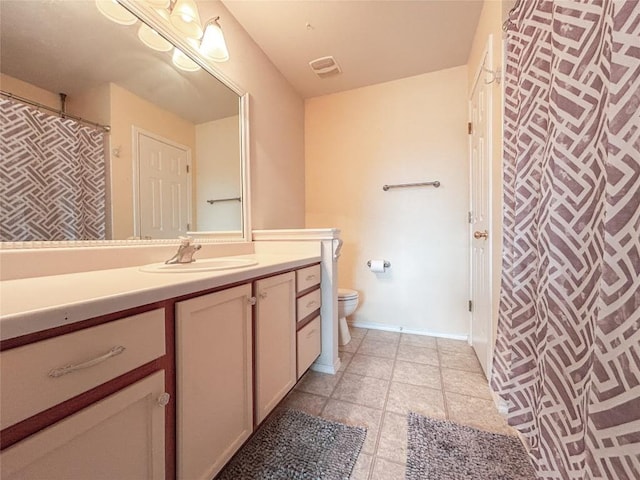 bathroom featuring tile patterned floors, vanity, and toilet