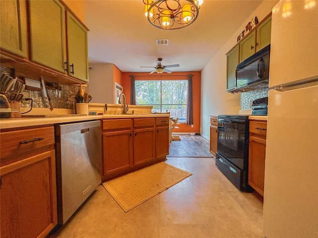 kitchen with decorative light fixtures, sink, black appliances, and ceiling fan with notable chandelier