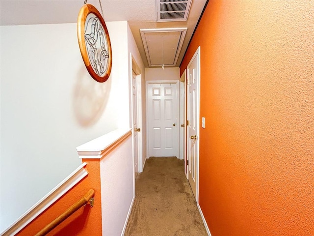 hall with light colored carpet