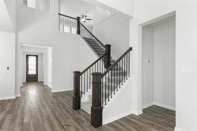 113 Wagon Spoke Way, Liberty Hill, TX 78642 - entrance foyer featuring wood finished floors, a towering ceiling, stairs, a ceiling fan, and baseboards