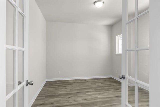 113 Wagon Spoke Way, Liberty Hill, TX 78642 - unfurnished bedroom with french doors and wood finished floors