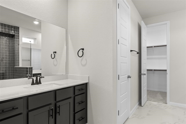 113 Wagon Spoke Way, Liberty Hill, TX 78642 - full bathroom featuring vanity, a walk in closet, and marble finish flooring