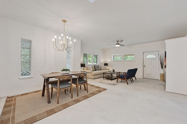 carpeted dining room featuring ceiling fan with notable chandelier