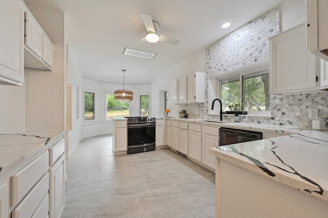 kitchen featuring white cabinets, hanging light fixtures, a healthy amount of sunlight, and black appliances