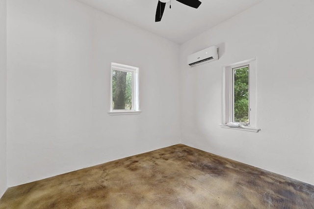 spare room featuring ceiling fan, a healthy amount of sunlight, and a wall mounted air conditioner