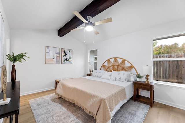 bedroom with lofted ceiling with beams, light hardwood / wood-style floors, and ceiling fan