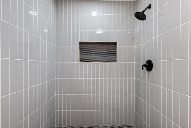 bathroom with tiled shower