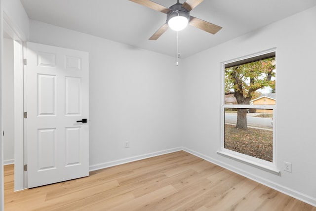 spare room featuring light hardwood / wood-style flooring and ceiling fan