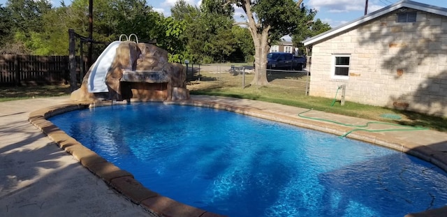 view of pool with pool water feature and a water slide