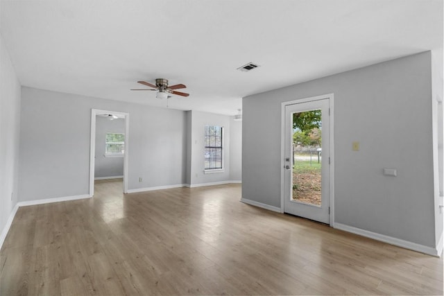 unfurnished living room featuring light wood-type flooring, ceiling fan, and a healthy amount of sunlight