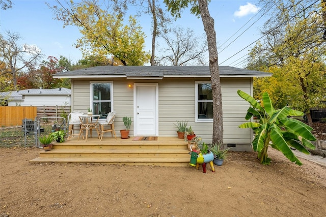 rear view of house featuring crawl space, fence, and a wooden deck