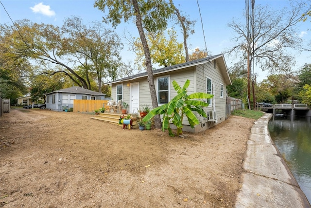 view of side of property with a deck with water view