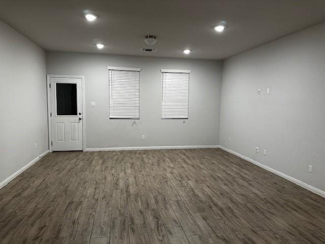 spare room with dark hardwood / wood-style floors