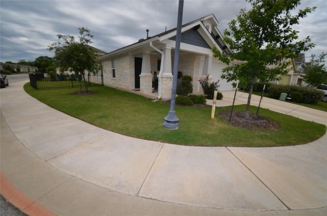 view of side of home with a garage and a yard