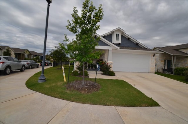 view of front of home with a garage and a front lawn