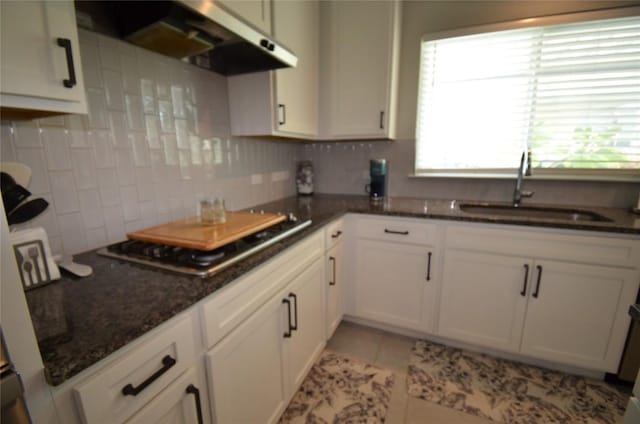 kitchen featuring ventilation hood, sink, light tile patterned floors, white cabinets, and stainless steel gas stovetop