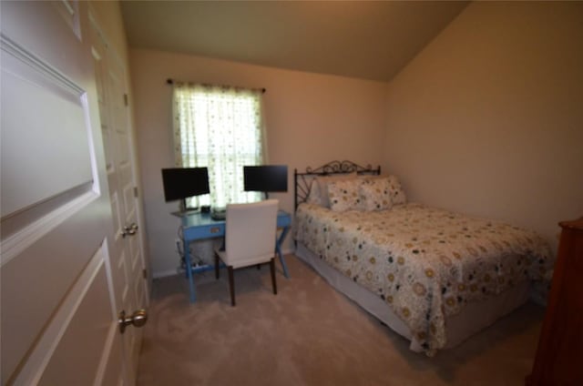 carpeted bedroom featuring vaulted ceiling