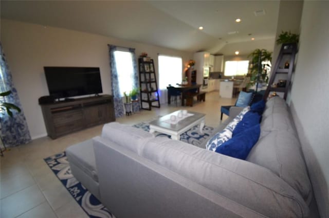 tiled living room featuring vaulted ceiling