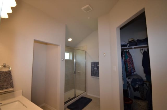 bathroom featuring vanity, an enclosed shower, and vaulted ceiling