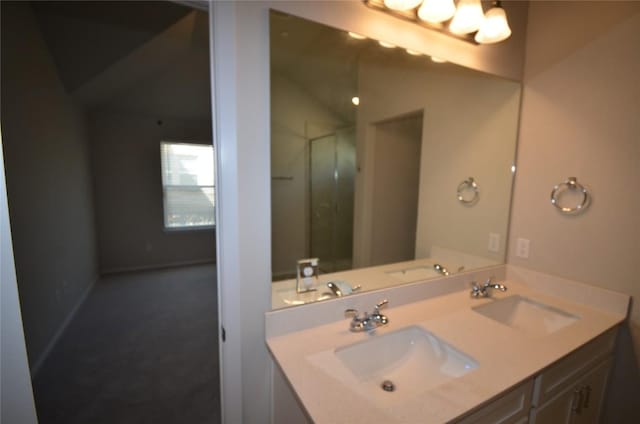 full bathroom with double vanity, an enclosed shower, vaulted ceiling, and a sink