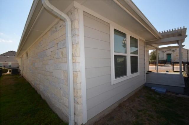 view of side of property featuring stone siding