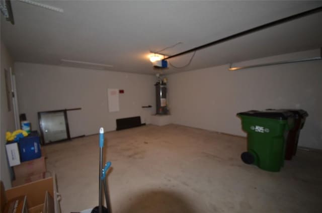 garage featuring a garage door opener and water heater