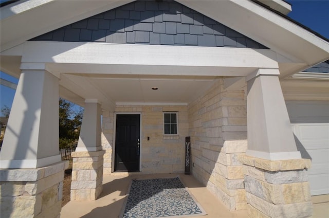 property entrance featuring stone siding and an attached garage