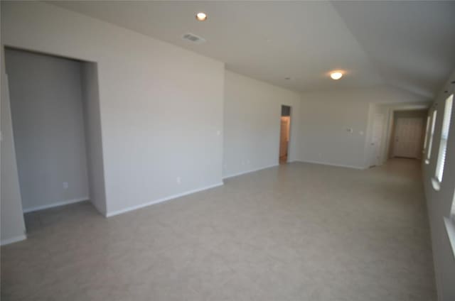 spare room with recessed lighting, visible vents, and lofted ceiling